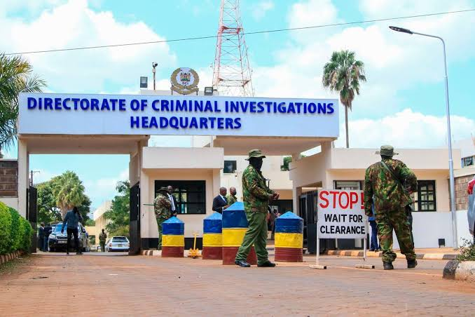The entrance to the Directorate of Criminal Investigations headquarters, with uniformed personnel outside.